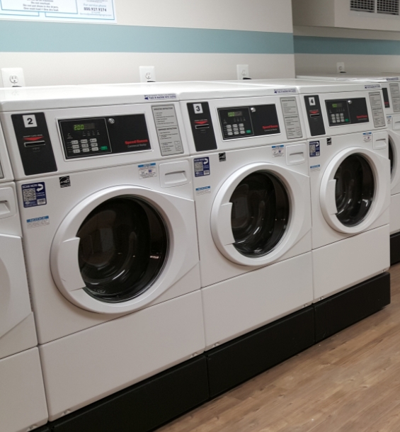 Commercial laundry machine units next to each other