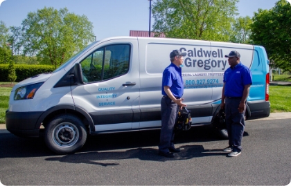 2 Caldwell & Gregory employees standing in to the side of a service van