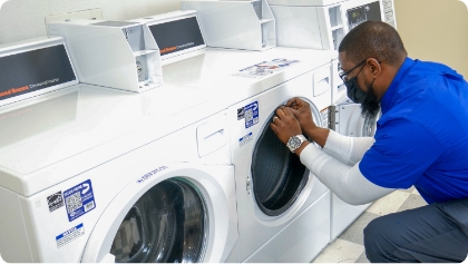 Caldwell & Gregory service technician working on a laundry machine