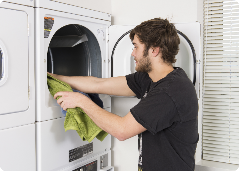 Student Taking Laundry From Dryer
