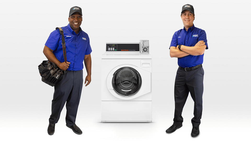 Two Caldwell & Gregory employees standing next to a laundry machine