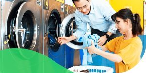 Couple folding laundry - How to set up a multi-housing laundry room