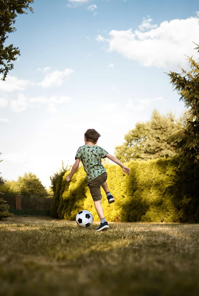 Boy in green shirt playing soccer